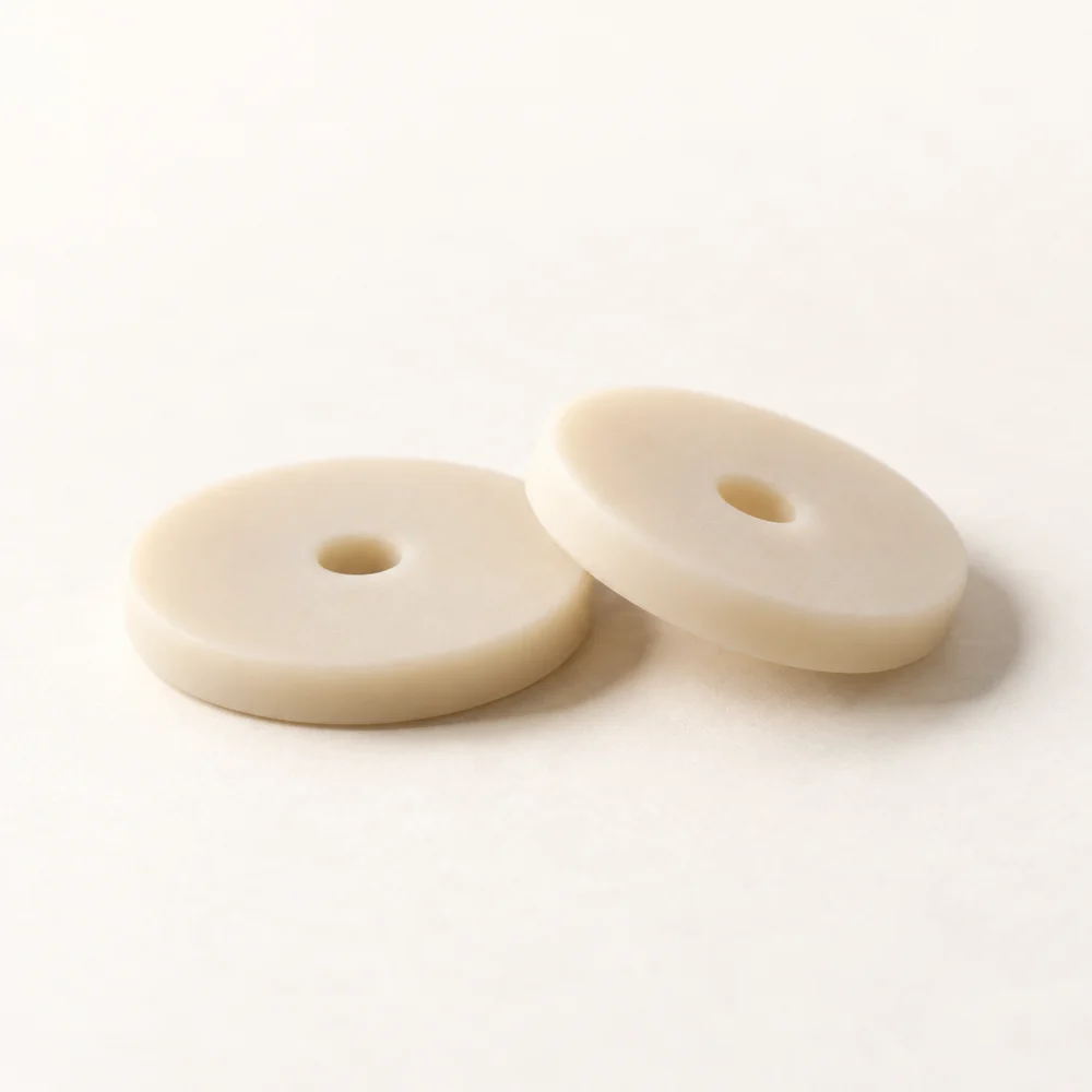Concept: two cream silicone spacers with round center holes